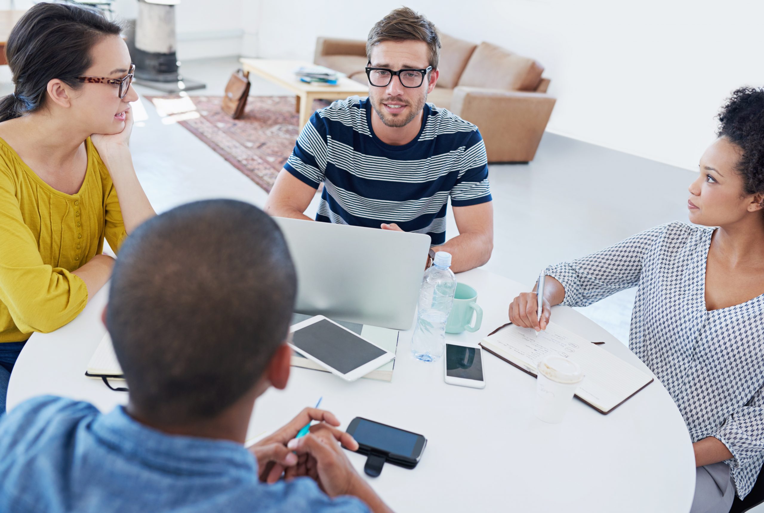 Workers discussing solutions around a table